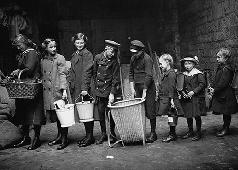 Historisches Schwarzweißfoto aus Braunschweig: Kinder stehen an, um Glasflaschen abzugeben - um 1915